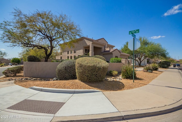 view of front of home featuring a fenced front yard and stucco siding