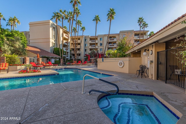 view of pool with a community hot tub and a patio