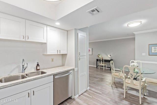 kitchen featuring light stone countertops, white cabinets, ornamental molding, sink, and dishwasher