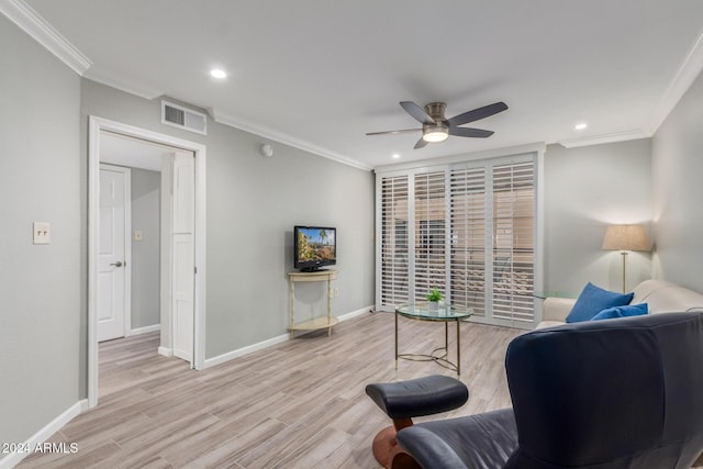 living area featuring crown molding, light hardwood / wood-style flooring, and ceiling fan