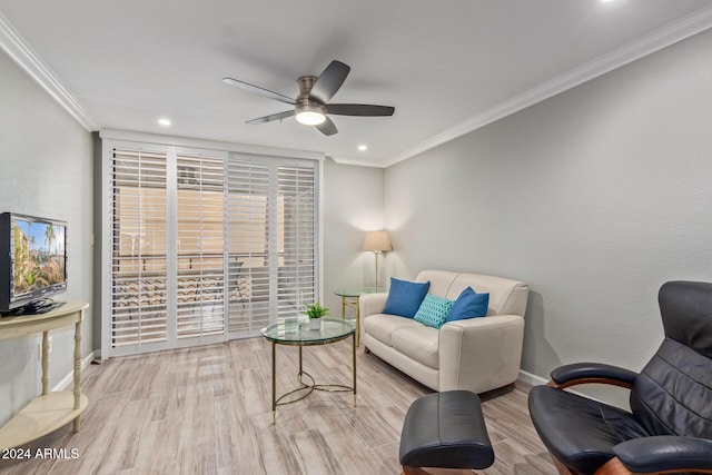 living room with crown molding, light hardwood / wood-style flooring, and ceiling fan