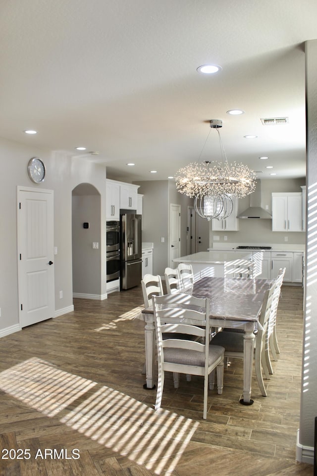 dining area featuring a chandelier and dark hardwood / wood-style flooring