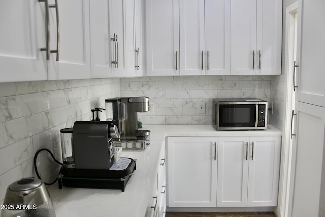 kitchen featuring decorative backsplash and white cabinets