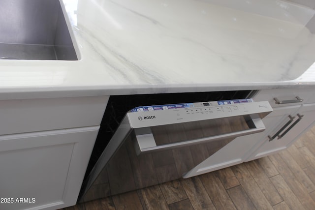 details with white cabinetry, dark wood-type flooring, and sink