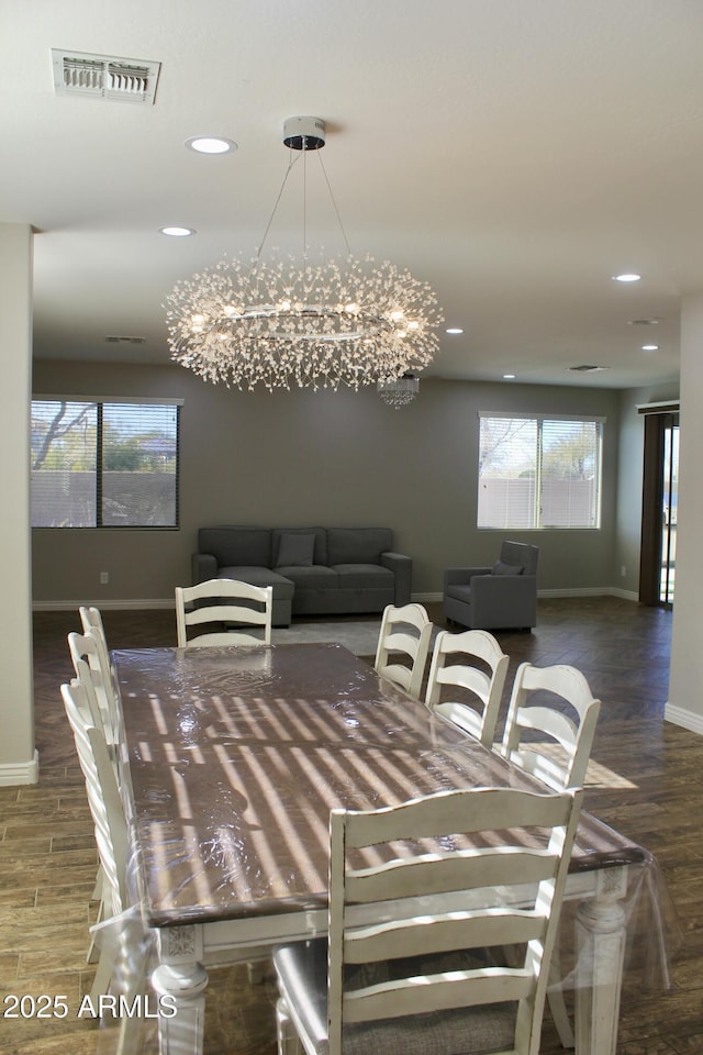 dining room featuring dark hardwood / wood-style floors and an inviting chandelier