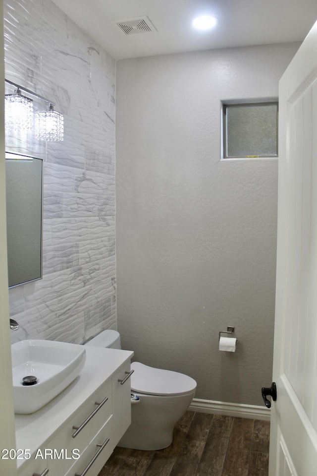 bathroom featuring hardwood / wood-style floors, vanity, and toilet