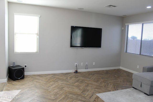 living room featuring a wealth of natural light and parquet floors