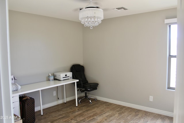 office featuring hardwood / wood-style flooring and a chandelier