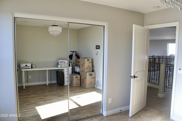 interior space featuring a closet, a chandelier, and wood-type flooring