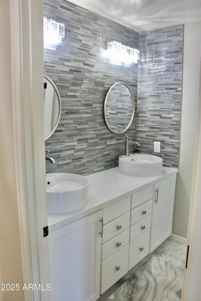 bathroom featuring decorative backsplash, vanity, and tile walls