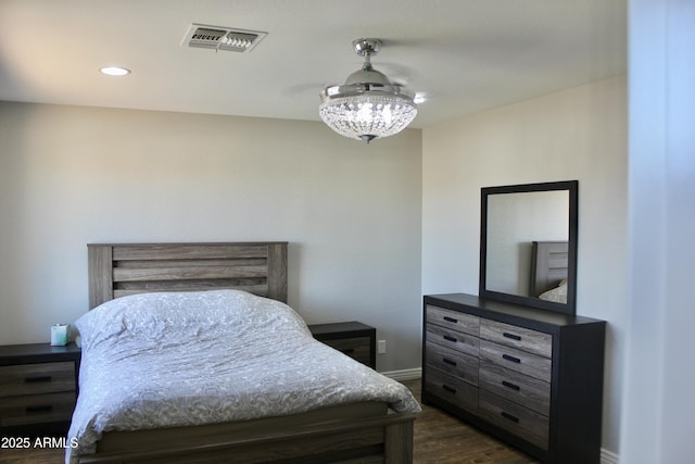 bedroom with dark wood-type flooring