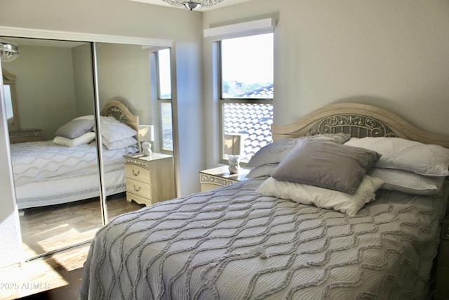 bedroom with hardwood / wood-style flooring and a closet