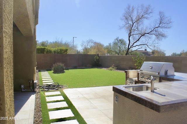 view of patio featuring area for grilling, sink, and exterior kitchen