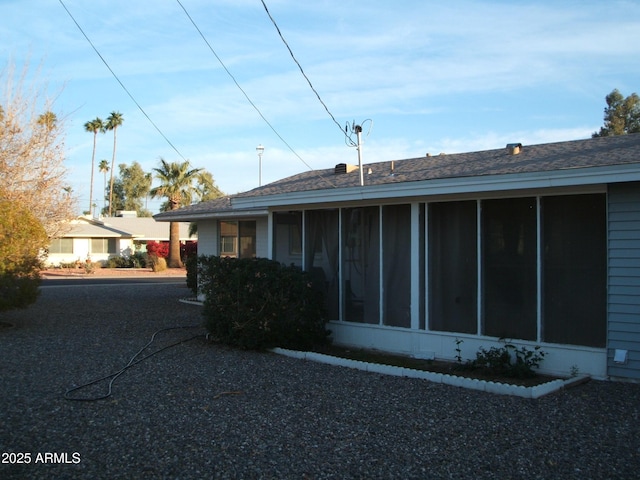 view of side of property featuring a sunroom