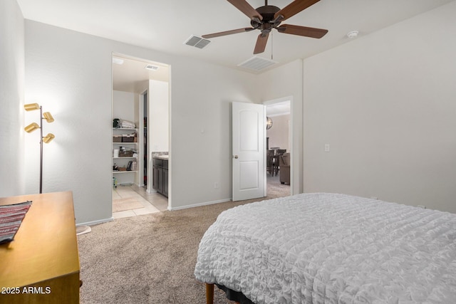 4556 E Gagarinite Ln, San Tan Valley, AZ 85143 - bedroom featuring visible vents, baseboards, ceiling fan, connected bathroom, and light colored carpet