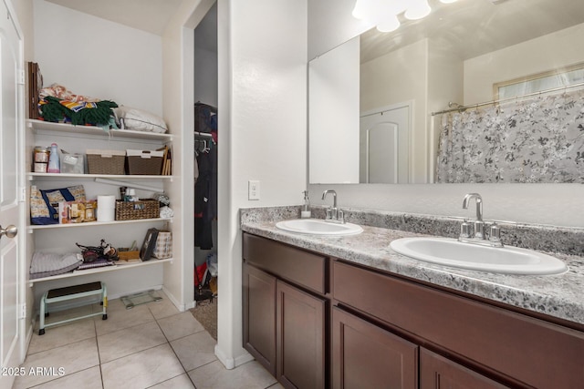 4556 E Gagarinite Ln, San Tan Valley, AZ 85143 - bathroom featuring a sink, double vanity, curtained shower, and tile patterned flooring