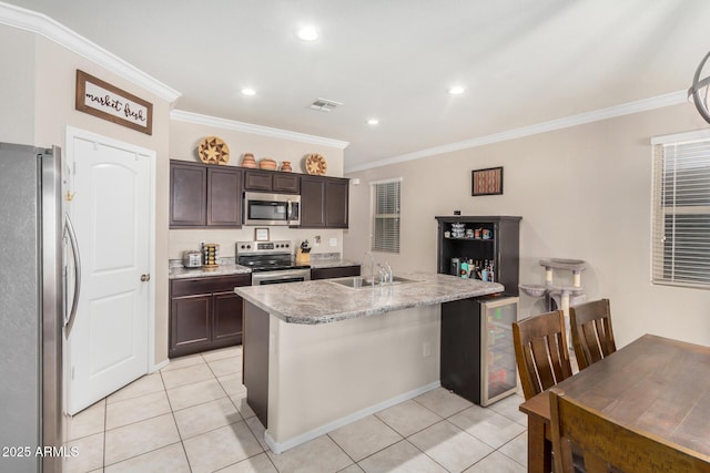 4556 E Gagarinite Ln, San Tan Valley, AZ 85143 - kitchen with stainless steel appliances, light tile patterned floors, visible vents, and ornamental molding