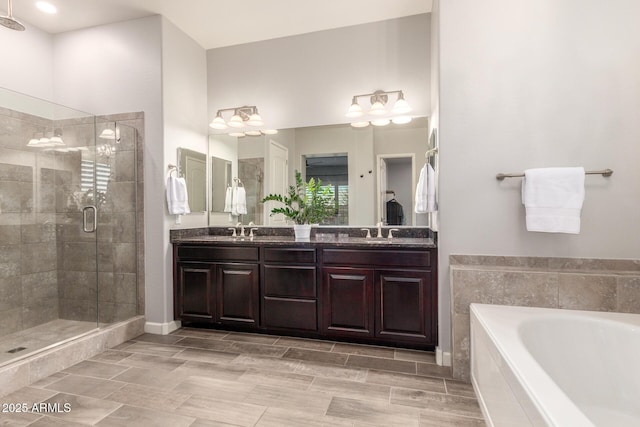 bathroom with vanity and independent shower and bath