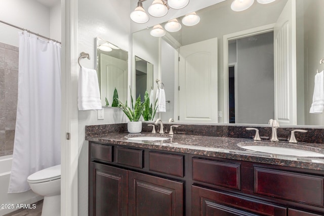 full bathroom with vanity, shower / bathtub combination with curtain, and toilet