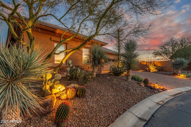 property exterior at dusk featuring a garage