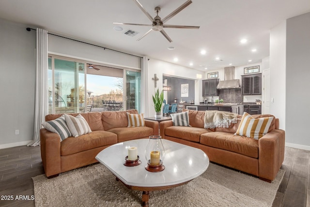 living room with dark hardwood / wood-style floors, sink, and ceiling fan