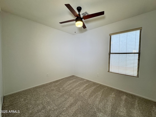 empty room with ceiling fan and carpet floors