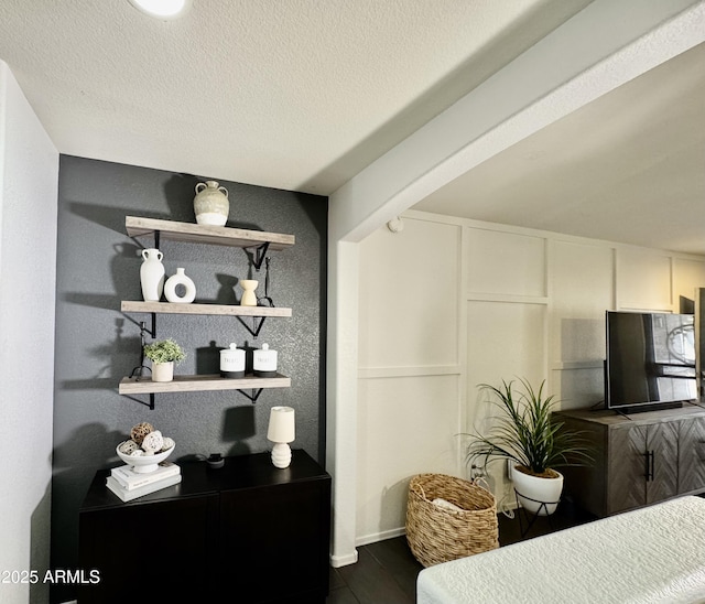 interior space featuring refrigerator, hardwood / wood-style floors, and a textured ceiling