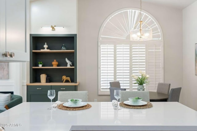 dining space featuring a notable chandelier and built in features