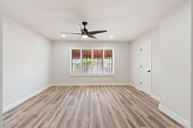 unfurnished room featuring recessed lighting, light wood-style flooring, a ceiling fan, and baseboards