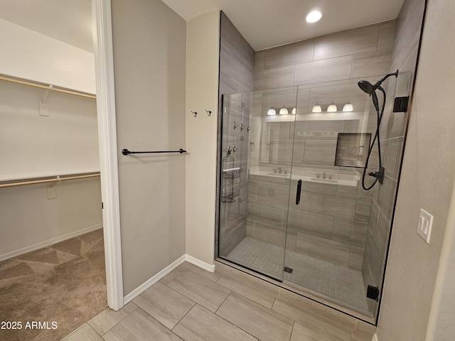 18871 S 209th Way, Queen Creek, AZ 85142 - bathroom with a shower stall, a spacious closet, and recessed lighting