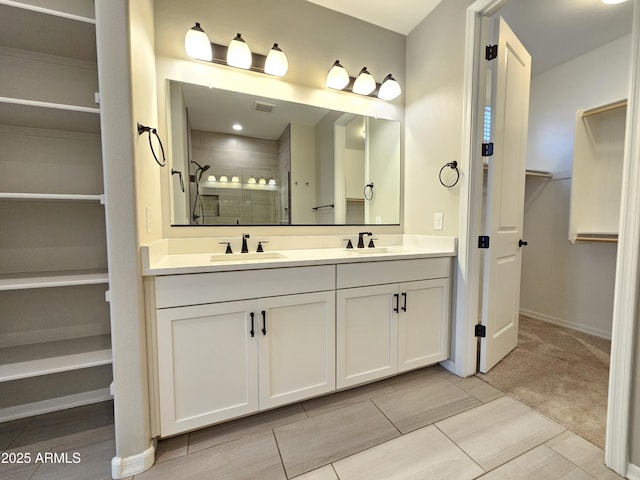 18871 S 209th Way, Queen Creek, AZ 85142 - bathroom with double vanity, a walk in closet, and a shower stall