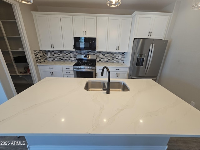 18871 S 209th Way, Queen Creek, AZ 85142 - kitchen with stainless steel appliances, a center island with sink, backsplash, white cabinetry, and light stone countertops