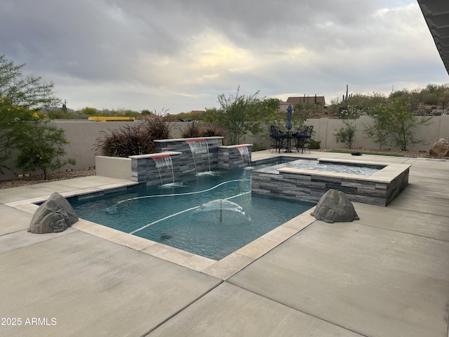 view of pool with a fenced backyard, a fire pit, a fenced in pool, an in ground hot tub, and a patio area