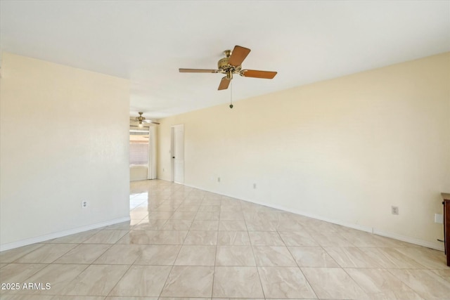 unfurnished room featuring a ceiling fan and baseboards