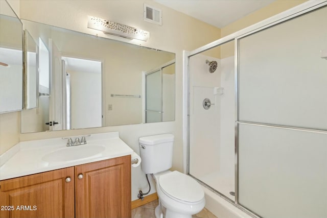 bathroom featuring vanity, toilet, visible vents, and a stall shower