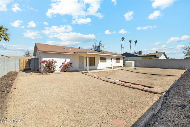 back of house featuring a fenced backyard, stucco siding, and a patio