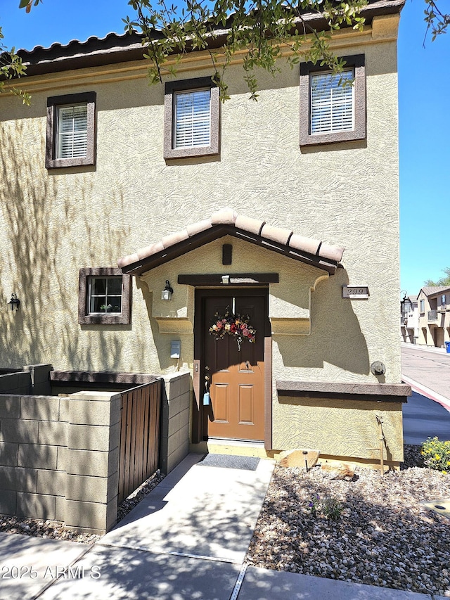 1265 S Aaron Unit 299, Mesa, AZ 85209 - view of front facade featuring stucco siding and a gate