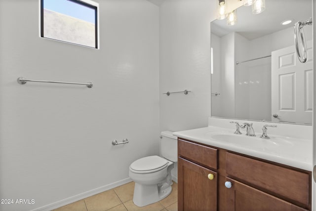 full bath with baseboards, a shower, toilet, tile patterned flooring, and vanity