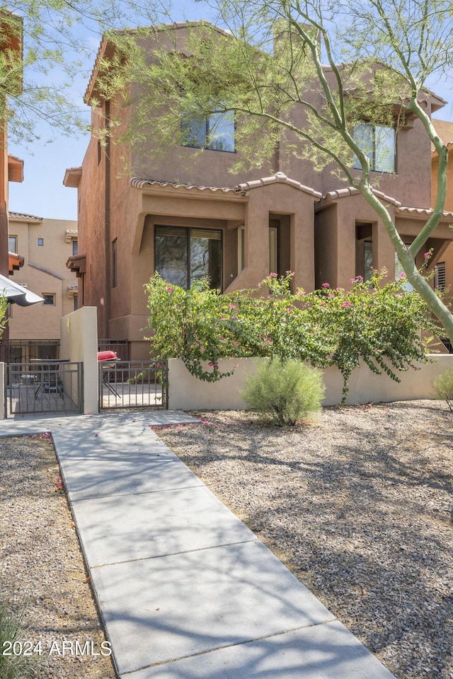 view of front of home featuring a gate and stucco siding