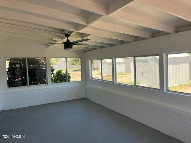 18045 N 20th Ln N, Phoenix, AZ 85023 - unfurnished sunroom featuring ceiling fan, beam ceiling, and concrete floors
