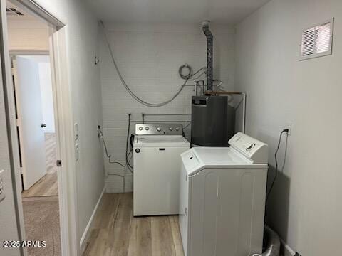 18045 N 20th Ln N, Phoenix, AZ 85023 - laundry room with water heater, washing machine and dryer, and light wood finished floors