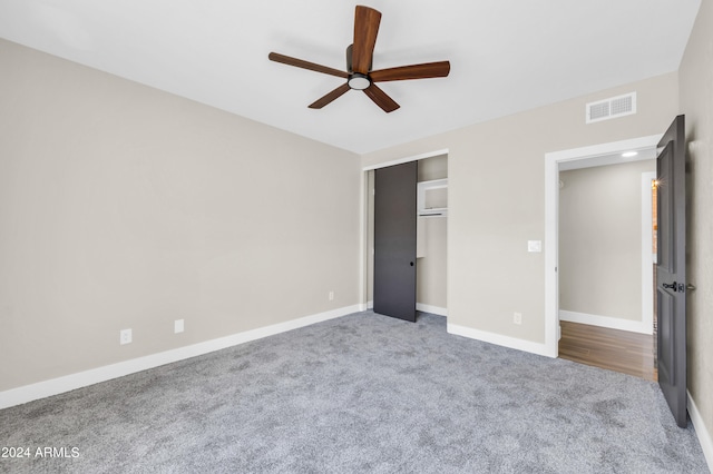 unfurnished bedroom featuring ceiling fan, carpet floors, and a closet