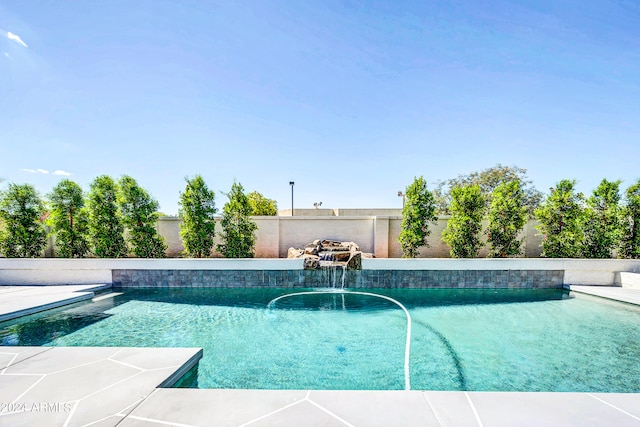 view of pool with pool water feature