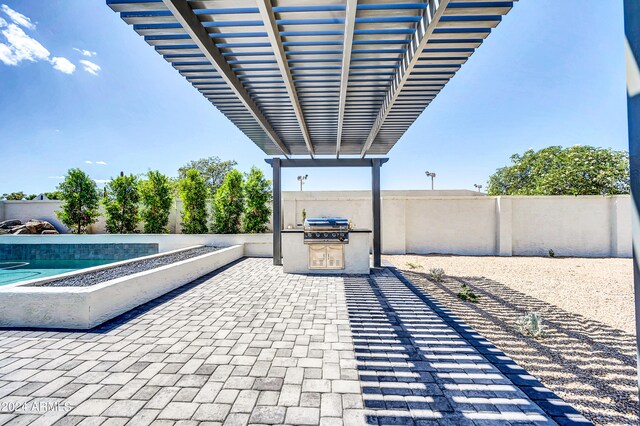 view of patio featuring a pergola, a grill, and an outdoor kitchen