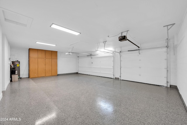 garage featuring electric water heater and a garage door opener