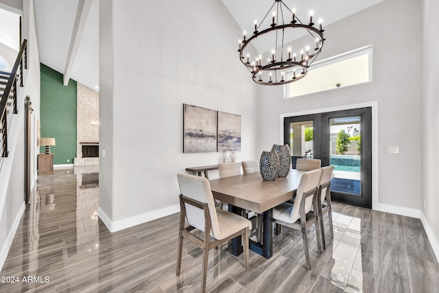 dining room with hardwood / wood-style floors, high vaulted ceiling, an inviting chandelier, french doors, and beam ceiling