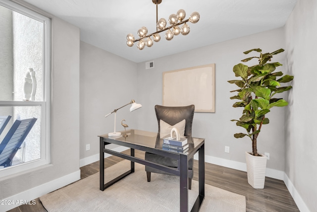 office area featuring hardwood / wood-style flooring and an inviting chandelier