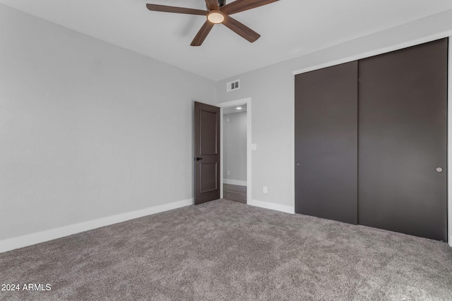 unfurnished bedroom featuring ceiling fan, a closet, and carpet floors