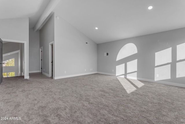 unfurnished living room featuring carpet and high vaulted ceiling