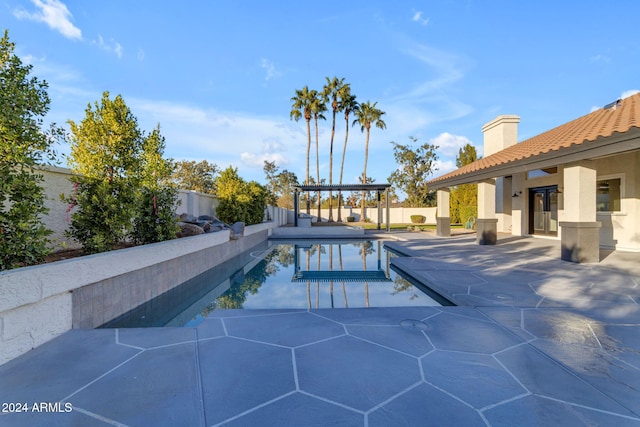 view of swimming pool with a pergola and a patio